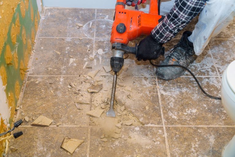 Renovation of old floor demolition old tiles with bath jackhammer