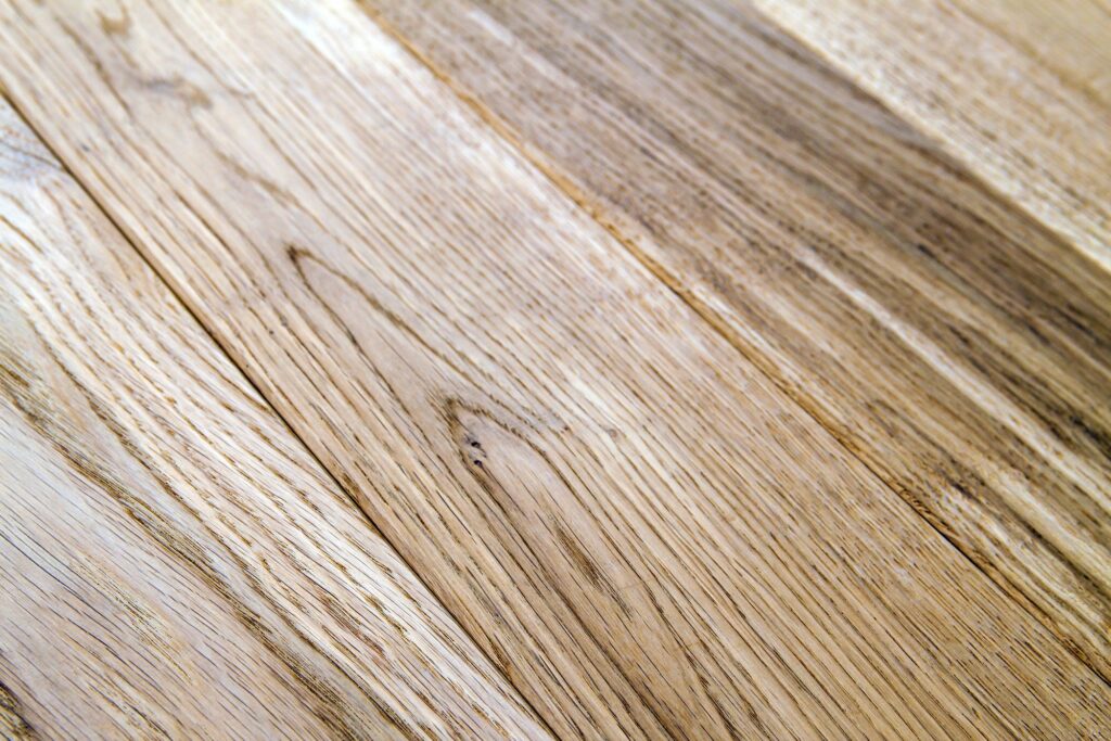 Several planks of beautiful laminate or parquet flooring with wooden texture as background