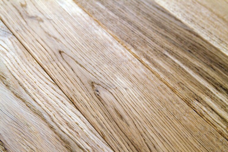 Several planks of beautiful laminate or parquet flooring with wooden texture as background